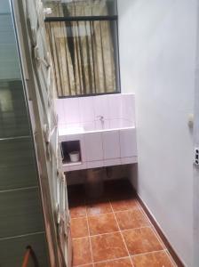 a bathroom with a white sink and a window at Apartamento Vallejo in Trujillo