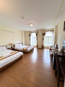 Postel nebo postele na pokoji v ubytování ANH ĐÀO HOTEL
