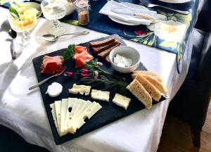 a plate of cheese and bread on a table at The Firs Boutique Bed and Breakfast, St Ives, Cornwall in St Ives
