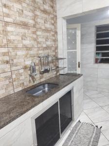 a bathroom with a sink and a shower at Casa de 3 quartos in Resende +23 photos