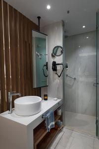 a bathroom with a sink and a shower at Calypso Beach in Faliraki