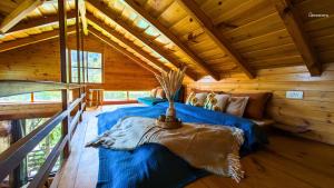 a bedroom with a bed in a log cabin at Shoonya Mukteshwar in Mukteswar +37 photos