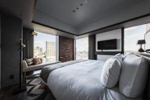 札幌SAPPORO STREAM HOTEL的卧室里有一张白色的大床，还有一扇大窗户