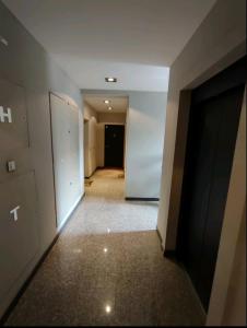 an empty hallway with a door in a building at Ada Luxury Apartment in Čukarica