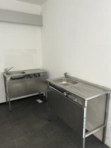 a kitchen with a sink and a counter top at HOSTEL Bahnhof in Frankfurt