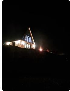 a house on top of a hill at night at Canerbey Çiftlik in Ovacık