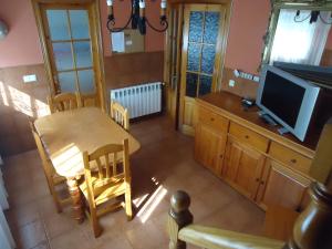 an overhead view of a kitchen with a table and a television at La Coruxa in Los Cabos