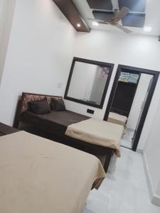 Habitación con 2 camas y 2 ventanas. en HOTEL PRAKASH PALACE, en Ujjain