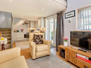 a living room with a tv and a couch and a chair at 1 Bed in Bassenthwaite 91211 in Bassenthwaite Lake