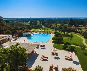 an aerial view of a resort with a swimming pool at Is Molas Resort in Pula