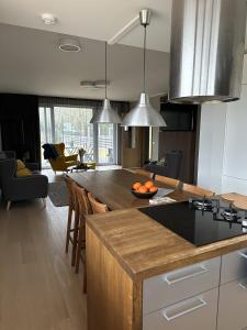 a kitchen with a large island with a counter top at A Cozy Retreat - Sauna & Garden - 3BDR in Pärnamäe