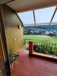 a balcony with a view of a green field at Villa La Flor de Anaga in Las Lagunas