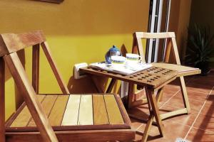 a table and chairs with a tea set on it at Villa La Flor de Anaga in Las Lagunas