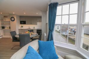 a living room with a couch and a large window at Queens View in Dartmouth
