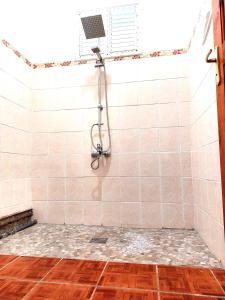 a bathroom with a shower with a fan at Maison de 3 chambres avec jardin amenage et wifi a Pointe Noire a 1 km de la plage in Pointe-Noire