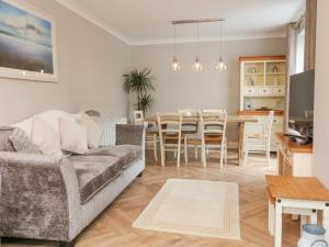 a living room with a couch and a table at Applestow in Bideford