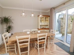 a kitchen and dining room with a wooden table and chairs at Applestow in Bideford
