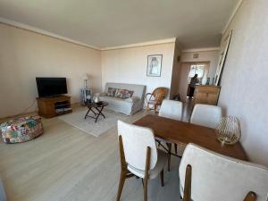 a living room with a table and a couch at Calme et vue exceptionnelle! in Banyuls-sur-Mer