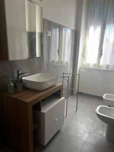 a bathroom with a sink and two toilets at Mari&Monti in Sapri +10 photos