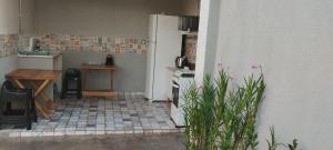 a small kitchen with a stove and a refrigerator at Pousada da Vila 1 in Araçariguama