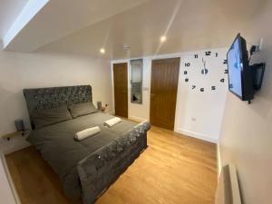 a bedroom with a large bed and a tv at LT Apartments 56 - Free St parking in Leicester