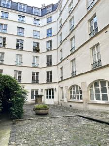 a large white building with windows and a courtyard at 1570 - Luxury spot in Paris Olympic Games 2024 in Paris