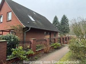 a red brick house with a black roof at Ferienwohnung Schröder in Putbus