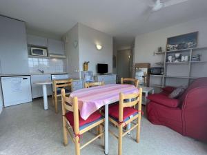 a kitchen and dining room with a table and a couch at Appartement Rochefort, 2 pièces, 4 personnes - FR-1-246B-51 in Rochefort