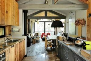 a kitchen with a counter and a dining room at Chalet Ilulissat in Courchevel