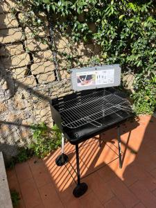 a grill sitting on top of a patio at Virgy Green House in Rome