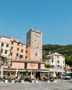 a building with a tower in the middle of a town at Capitolare Suite Tower in Portovenere