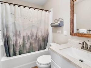 a bathroom with a toilet and a shower curtain with trees at Smoky Bear Lodge at Gr Smoky Mtn Park in Bryson City +43 photos