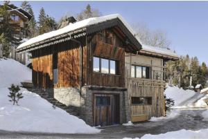 Une petite maison avec de la neige au-dessus dans l'établissement Le chalet Ikamiut, à Courchevel