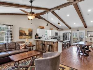 a living room with a couch and a table at Smoky Bear Lodge at Gr Smoky Mtn Park in Bryson City