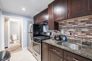 a kitchen with a sink and a stove at MODERN Updated Rare 2BR Condo in Washington