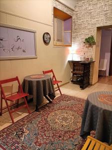 Rossi Hotel في روما: غرفة معيشة مع طاولتين وبيانو