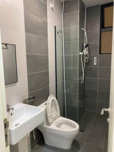 a bathroom with a shower and a toilet and a sink at Modern Lux Suite, The Cove Hillside Residence in Ipoh