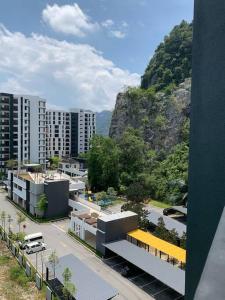 a view of a city with buildings and a mountain at Modern Lux Suite, The Cove Hillside Residence in Ipoh +24 photos