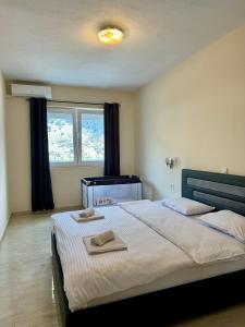 a bedroom with a bed with two towels on it at Apartments Seaview Estate Radovic in Kotor