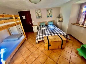 a bedroom with a blue bed and a wooden floor at B&B La Presa in Molino del Pallone