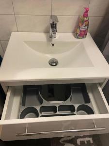 a white bathroom sink with a sink at gemütliches Apartment in Marl - WG 1 in Marl