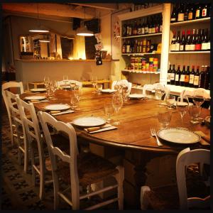 a large wooden table with chairs and wine glasses at B&B Vigne Vierge in Aigne