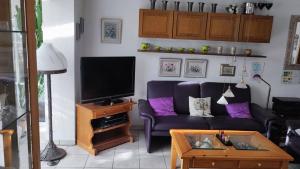 a living room with a couch and a tv at Ferienhaus Ebert, Top-Ausstattung mit Garten, Terrasse & Wall-Box bei Dinkelsbühl in Dinkelsbühl