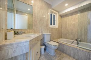 a bathroom with a toilet and a tub and a sink at Stunning - Seaview Penthouse 3-Bed + Parking in Sliema +23 photos