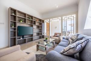 a living room with a couch and a tv at Stunning - Seaview Penthouse 3-Bed + Parking in Sliema