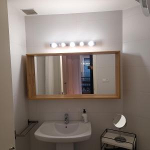 a bathroom with a sink and a mirror at Bardenas de Tudela in Tudela +7 photos