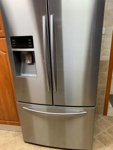 a stainless steel refrigerator in a kitchen at Stanley Hostel in Dubai