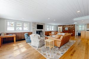 a living room with a couch and two chairs at Winnisquam Sunrise in Sanbornton