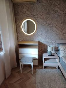 a bedroom with a bed and a mirror and a table at Lighthouse 1bedroom GeC apartment 203 in Balchik +5 photos