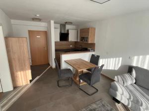 a living room with a table and chairs and a couch at Ferienwohnung-Blume EG 2 in Wolfach